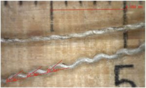 Fig. 4: The upper yarn is a weft thread, the lower yarn a wavy warp thread, from a linen canvas.