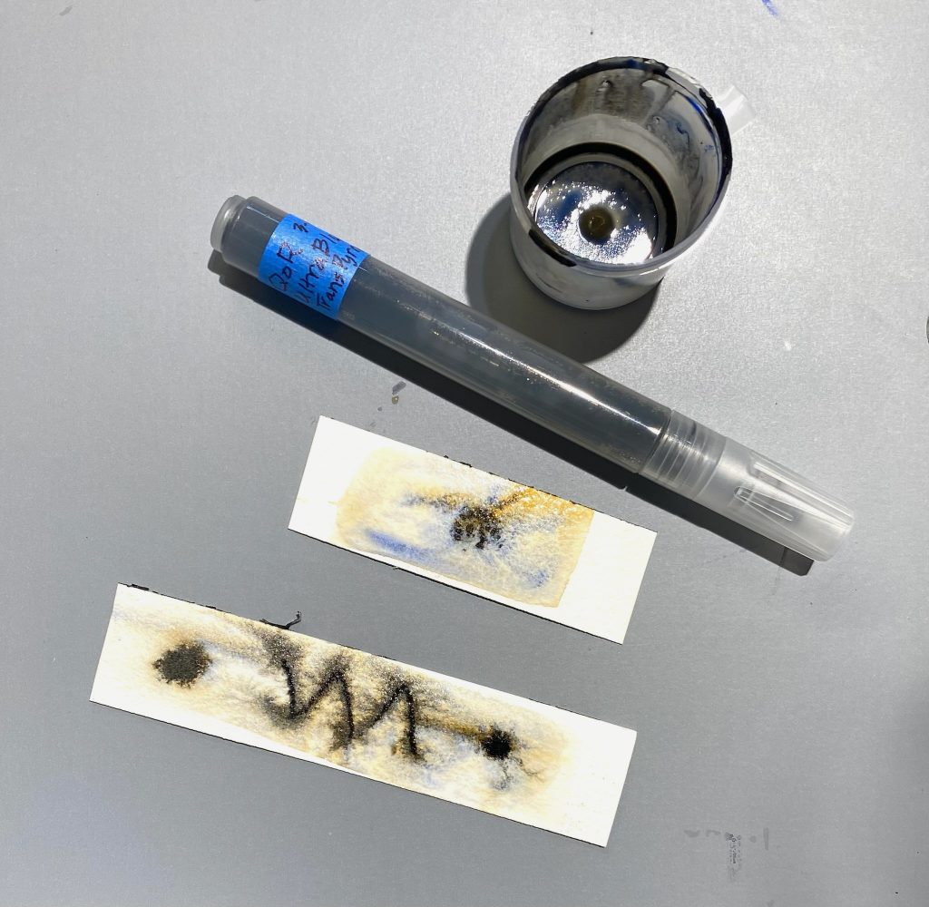 image of test on wet paper once empty paint marker is loaded with diluted mixed QoR Watercolor