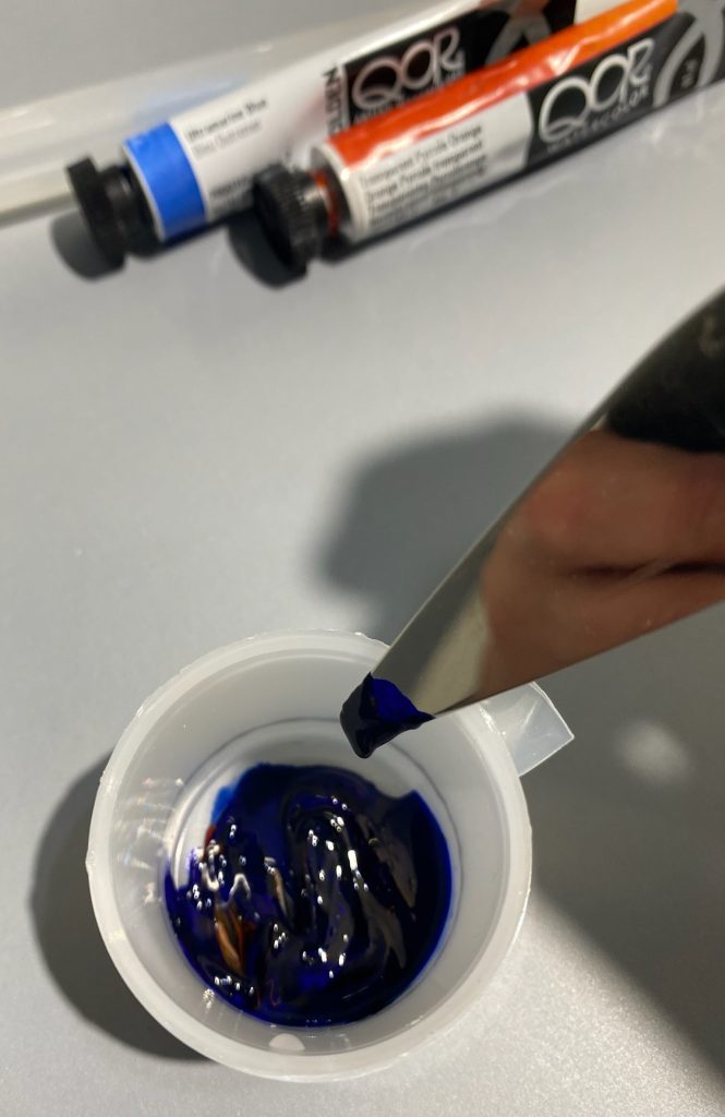 image of mixing watercolor in cup